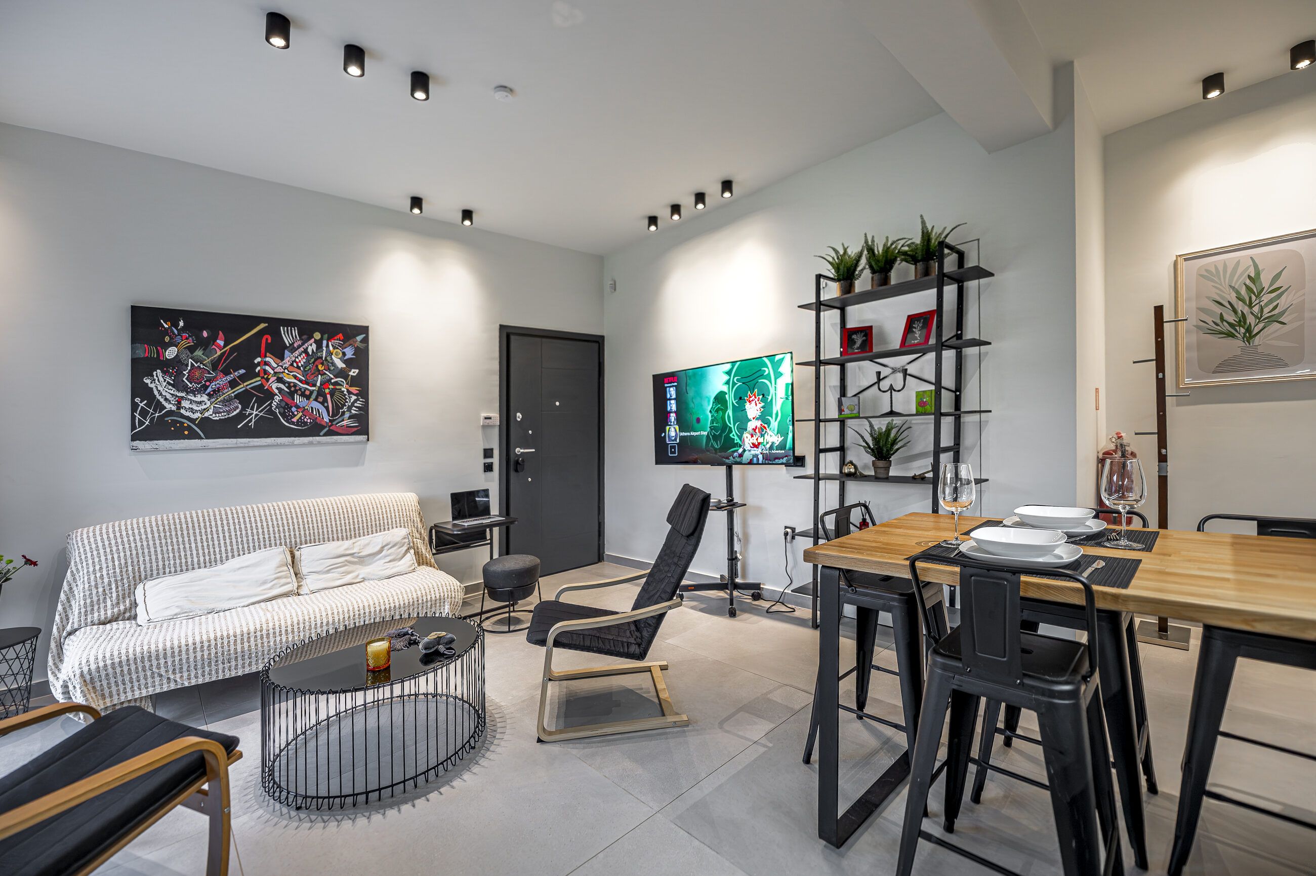 Living area from the far corner, with the desk, the shelving and the dining table