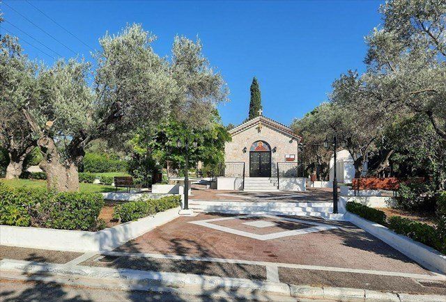 The Agia Dynami chapel on its square in Christoupoli, olive trees and quiet streets around it