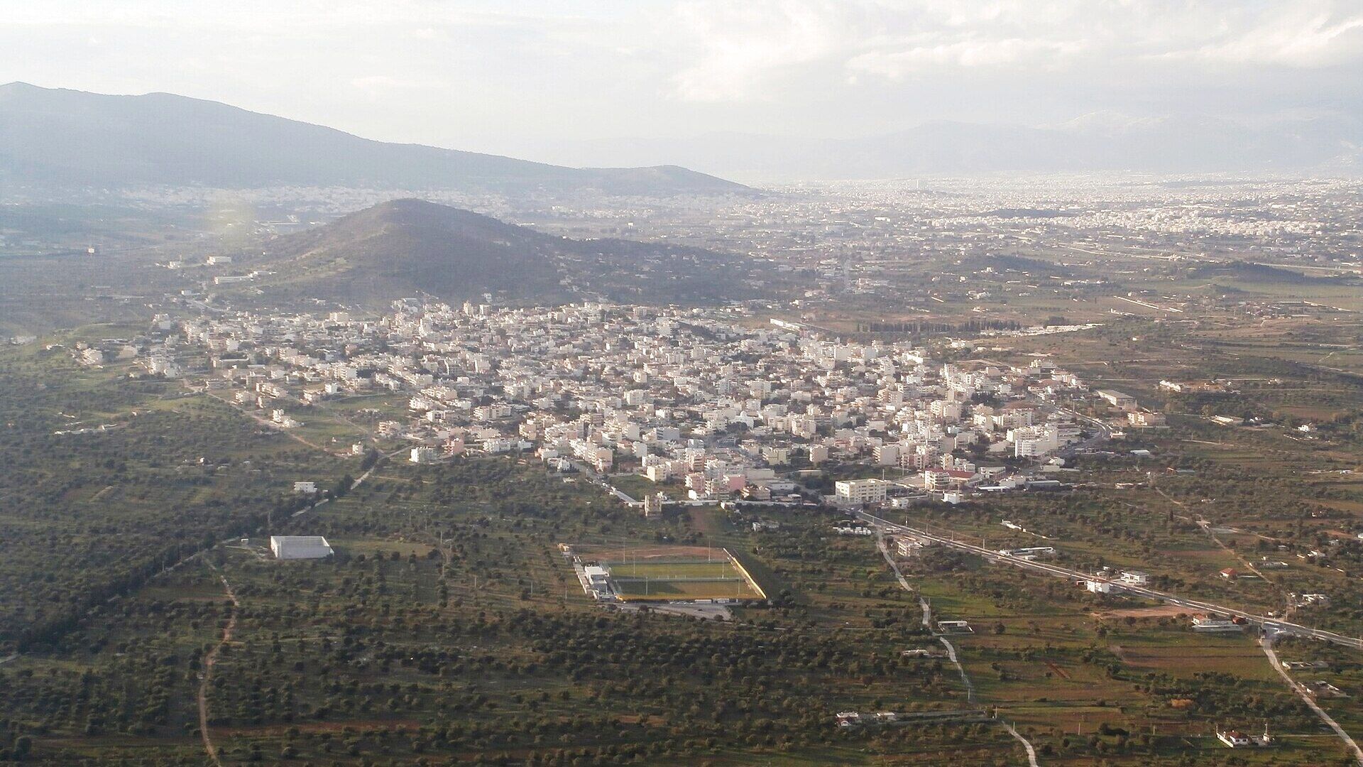 Spata from the air, the town among the olive groves of east Attica with Athens on the horizon